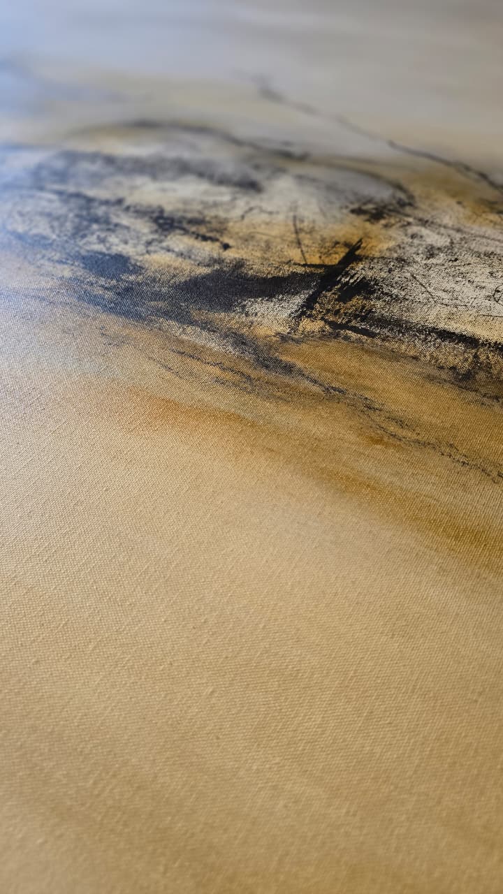 Raking light across gestural marks and canvas weave